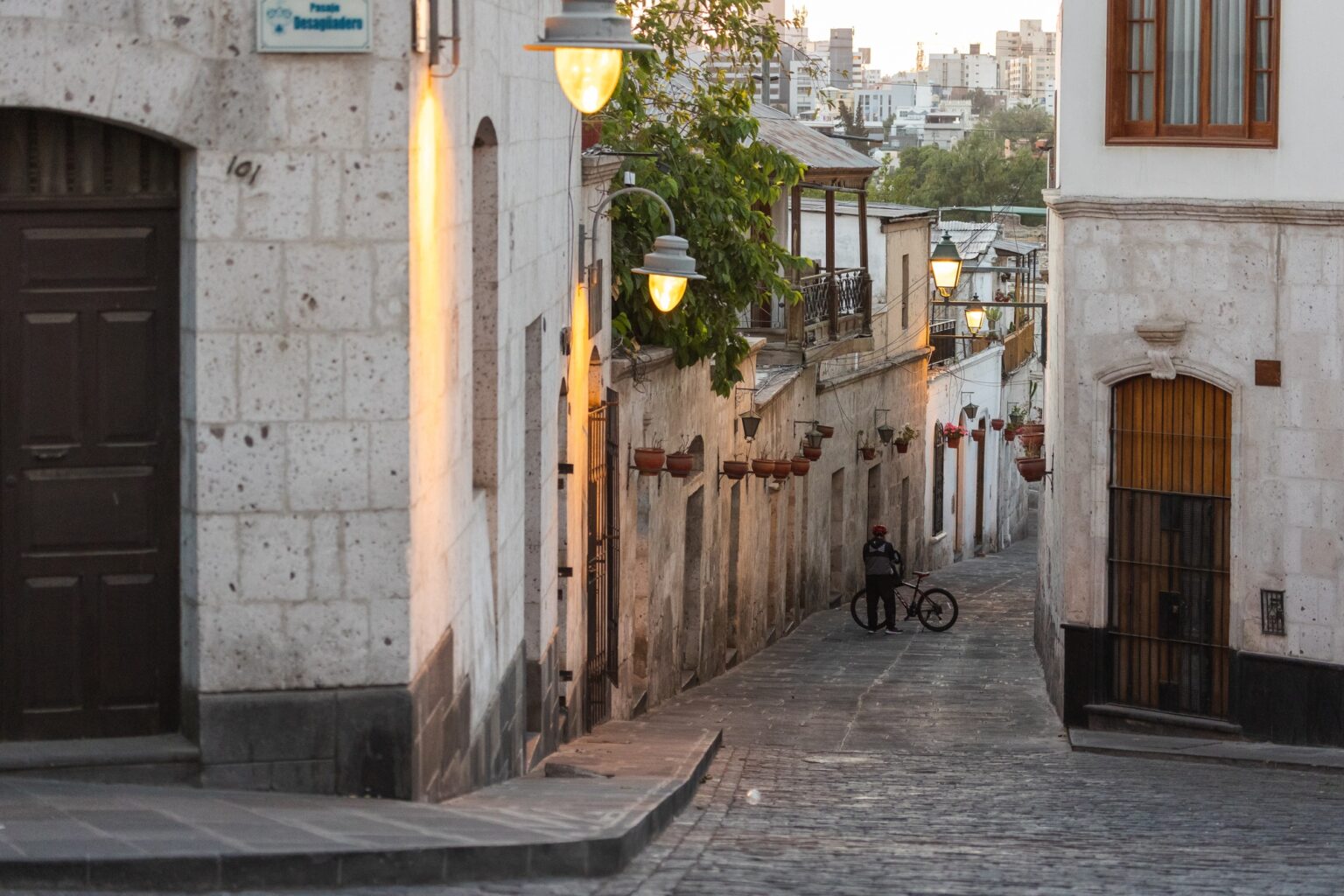 A bicyclist taking a break down a gorgeous alleyway in Arequipa